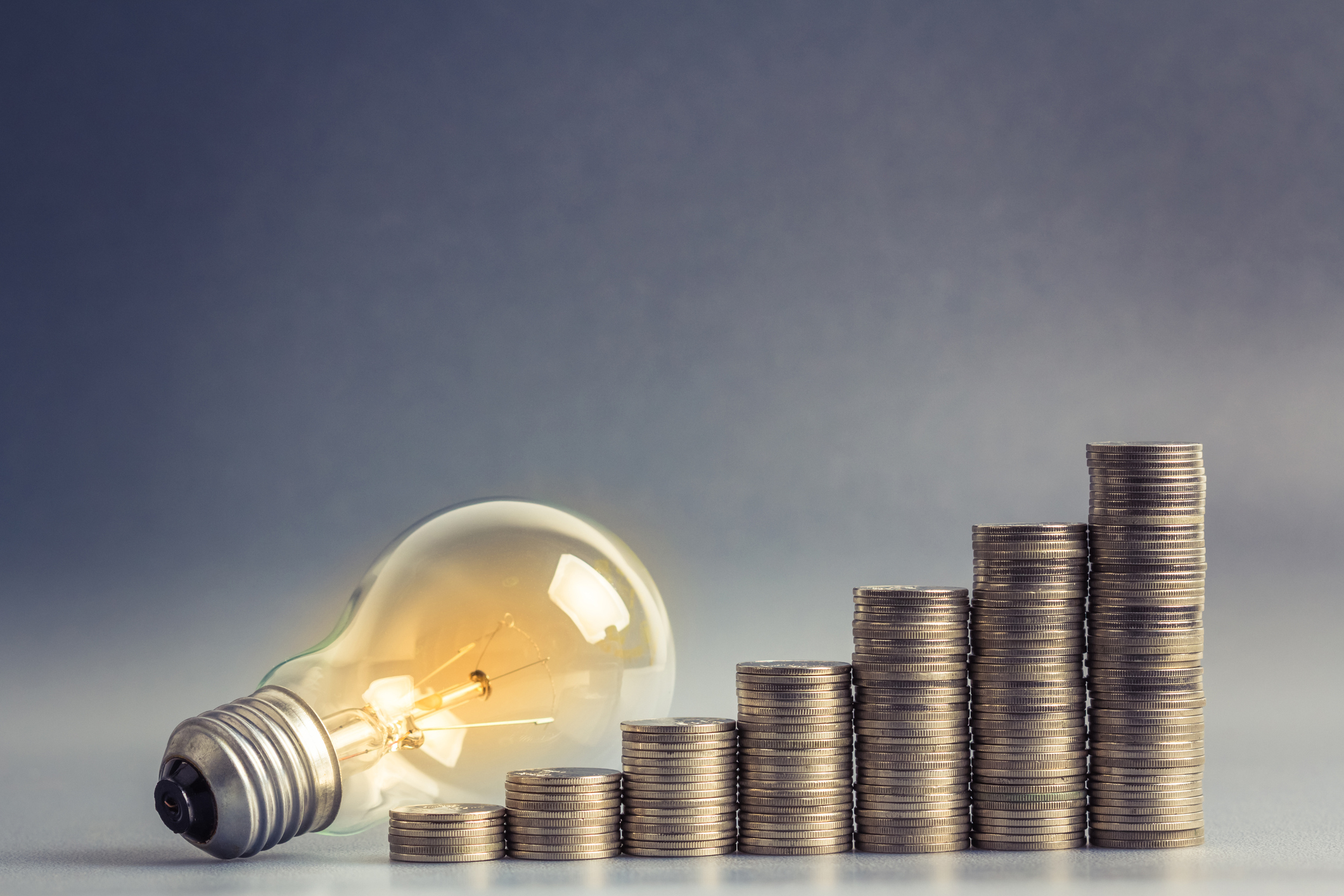 What are the disadvantages of going with cheap solar brands? light bulb with stacked coins