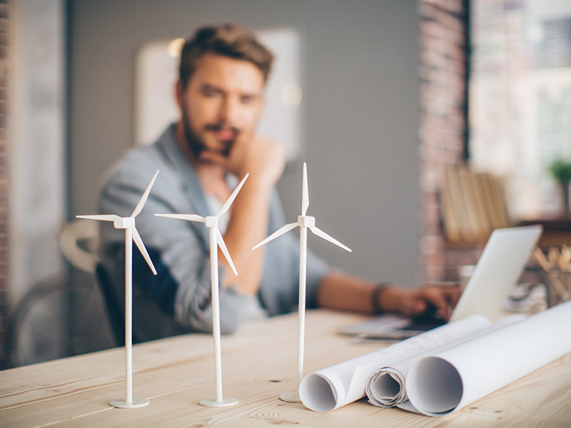 What issues do I need to consider when buying solar panel kits? man looking at model wind turbines