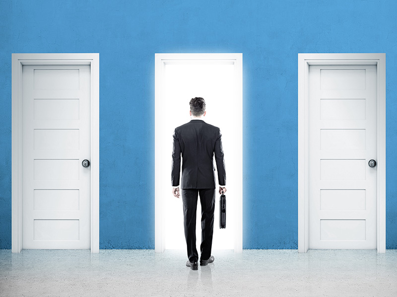 Man standing in front of 3 doors