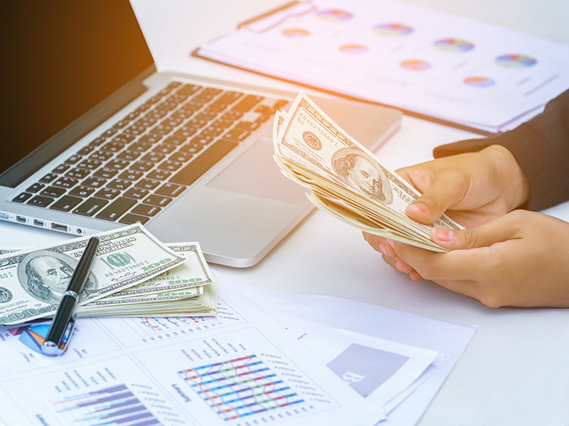 person-at-desk-holding-money