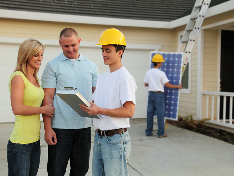 What is included when we talk about the installed cost in a quote from a solar company? couple discussing the installation of solar panels on their home