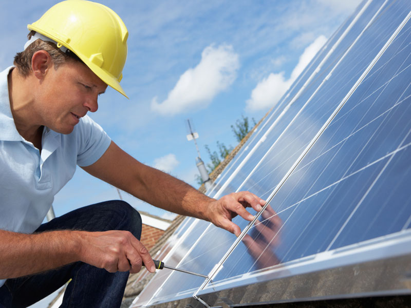 Selecting a solar installer man installing solar panels