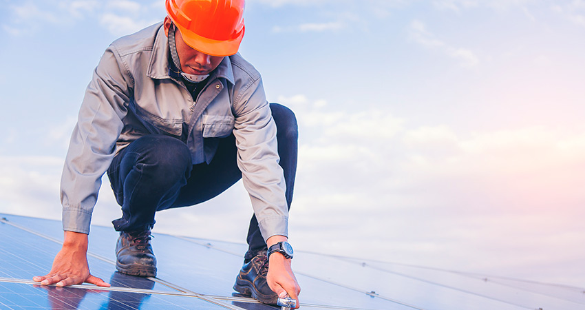 Technician installing solar panels