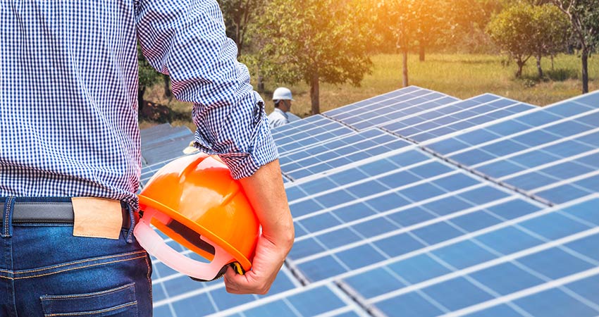 Man standing in front of solar panels