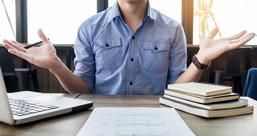 Man-shrugging-at-desk